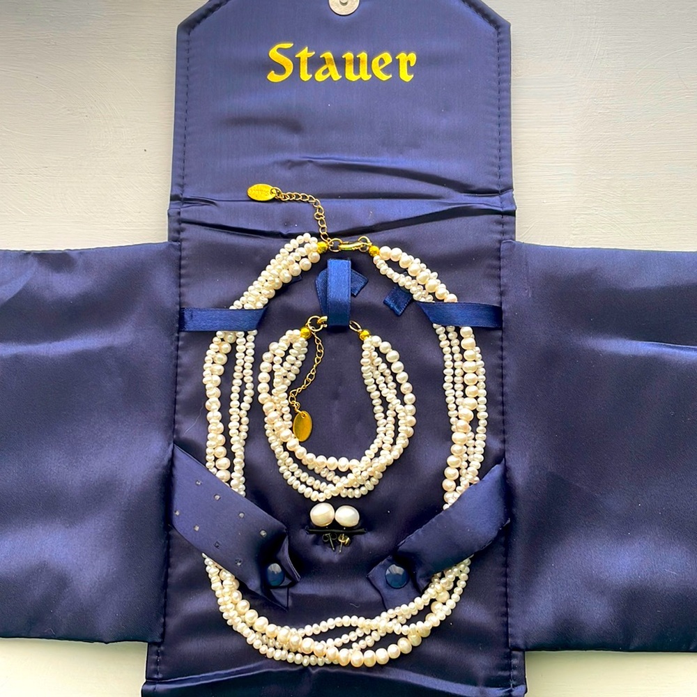 Pearl necklace, bracelet, and earrings set.